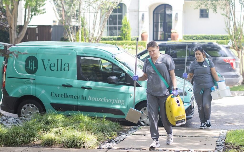 Two housekeeping professionals carrying cleaning tools and supplies Two housekeeping professionals carrying cleaning tools and supplies, ready to deliver excellence in housekeeping services.