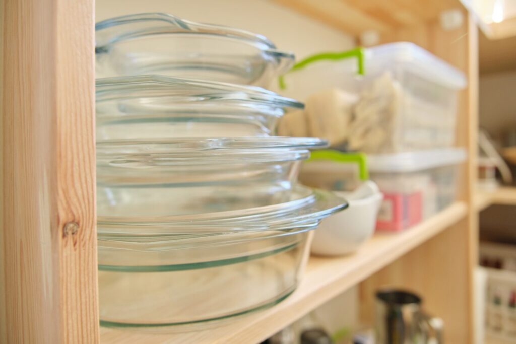 Neatly organized pantry shelves in Dallas with glass containers of dry goods stacked by category.