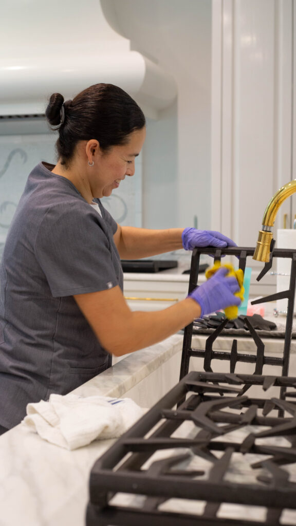 Vella’s staff is cleaning the stove tops with non-toxic cleaners in Plano.