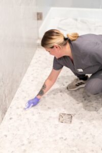Vella’s staff cleaning the bathroom floor using bleach.
