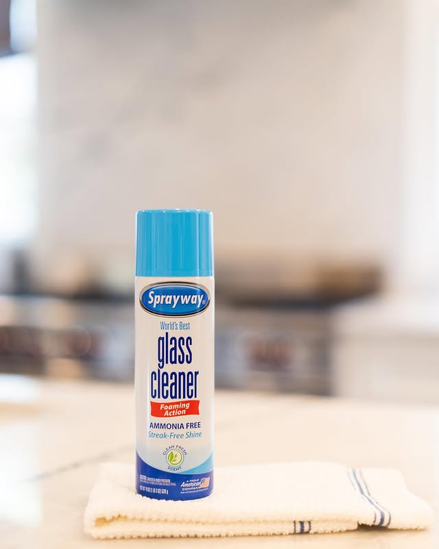 Sprayway ammonia-free glass cleaner bottle placed on a towel, showcasing eco-friendly cleaning options.