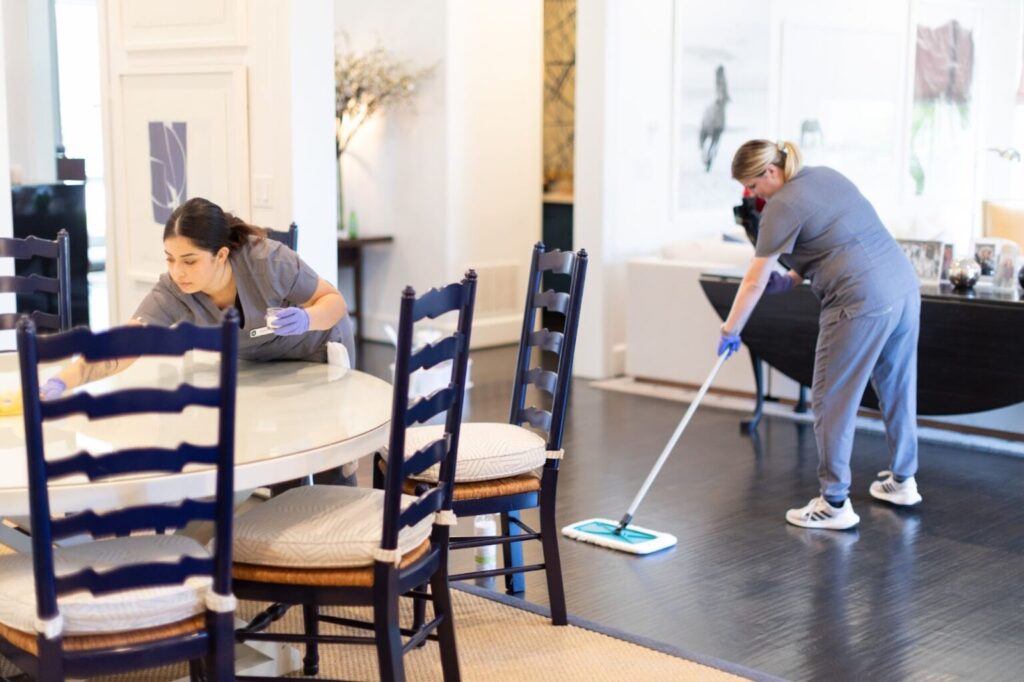 Vella’s staff mopping the floor and cleaning the dining table.