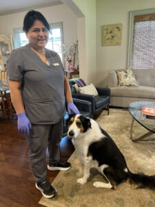 Vella’s staff standing with a pet dog in Dallas.