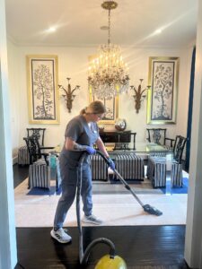 A housekeeper from Vella is vacuuming the floor of a home in Texas.