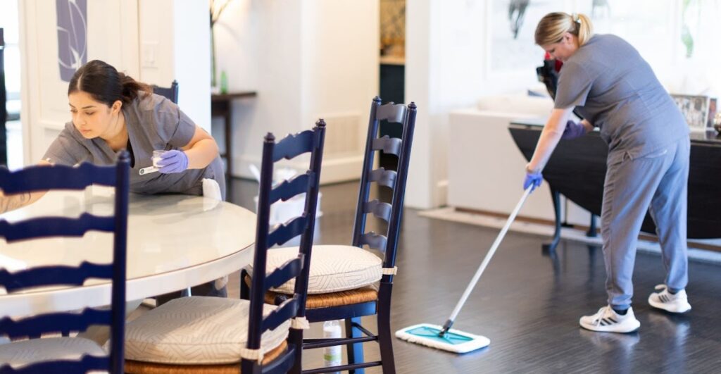 Two professional cleaners working in a home Two professional cleaners working in a home, demonstrating the quality of residential cleaning services near you.