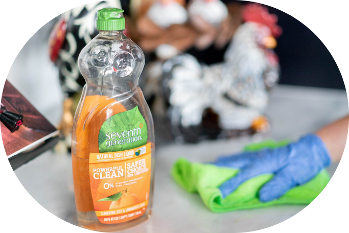 Eco-friendly dish soap like Seventh Generation Natural Dish Liquid on a kitchen counter with a reusable cloth.