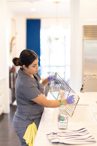Vella’s cleaning staff removes the dirt from a stainless steel rack with an eco-friendly cleaning solution.