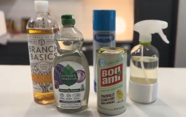 Assorted eco-friendly cleaning products including Branch Basics, Seventh Generation, Bon Ami, and an all-purpose spray on a white countertop.